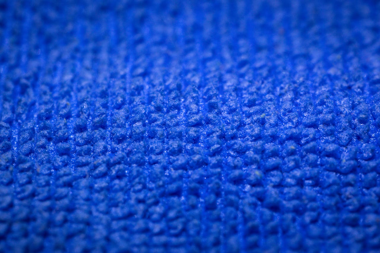 Detailed close-up of a soft blue microfiber fabric showing intricate texture.